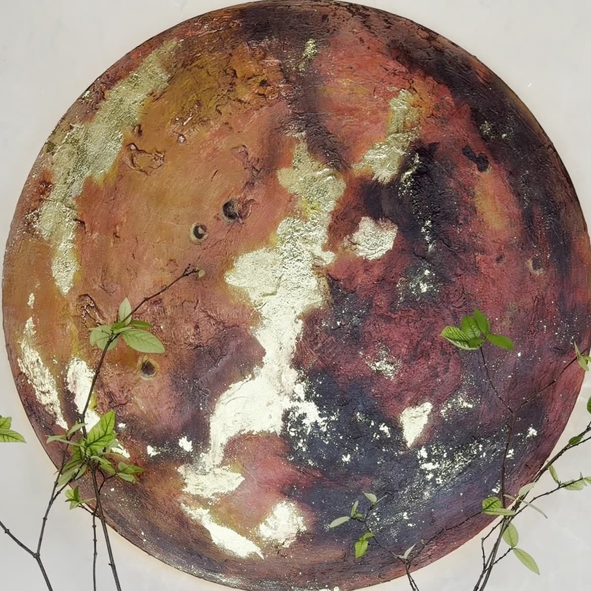 The MARS house artwork: a textured painting of Mars with gold leaf